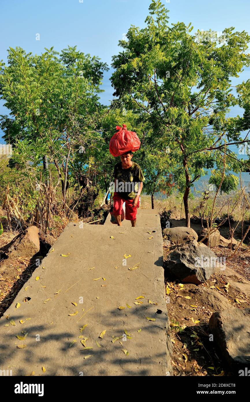 Fresh water, groceries, foods, must go up to the village where about 300 steps up to the hill.  Taken @Lamagute village, Lembata, East Nusa Tenggara, Stock Photo