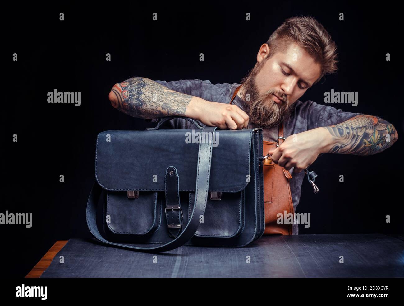 Leather Professional performs leather working for a new product Stock Photo