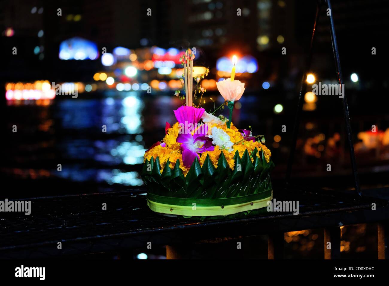 Flower cockerel with candle and incenses by the river 3 Stock Photo