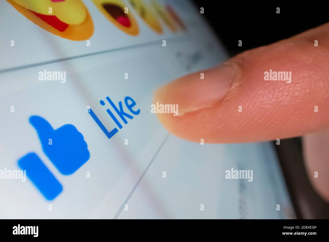 Macro shot of clicking the like button in Facebook Stock Photo