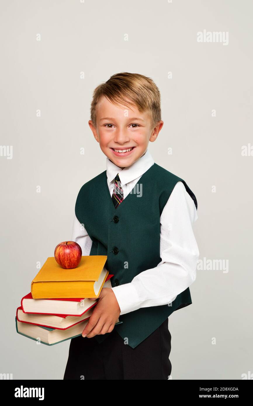 Portrait Handsome Schoolboy In Uniform In Front Of White Background Cute Guy Hold Books And Apple Day Of Knowledge September 1 World Read Aloud Day Stock Photo Alamy