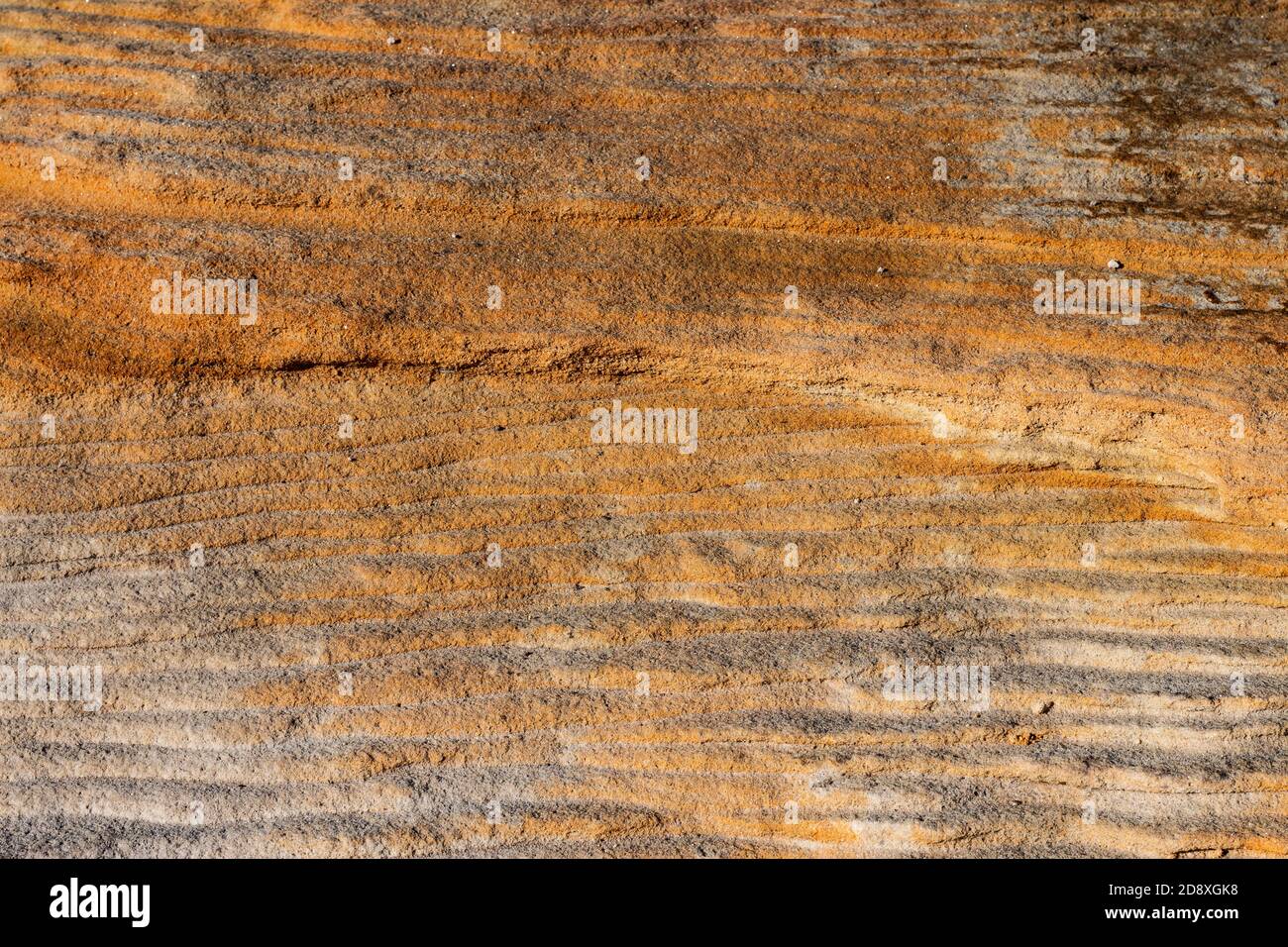 Natural sandstone rock rippled textured surface ideal as background Stock Photo