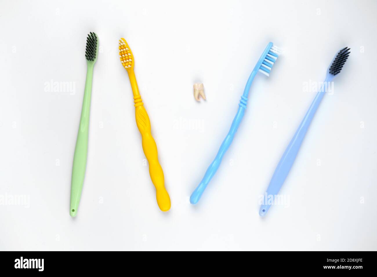 Four colorful toothbrushes on isolated white background Stock Photo - Alamy