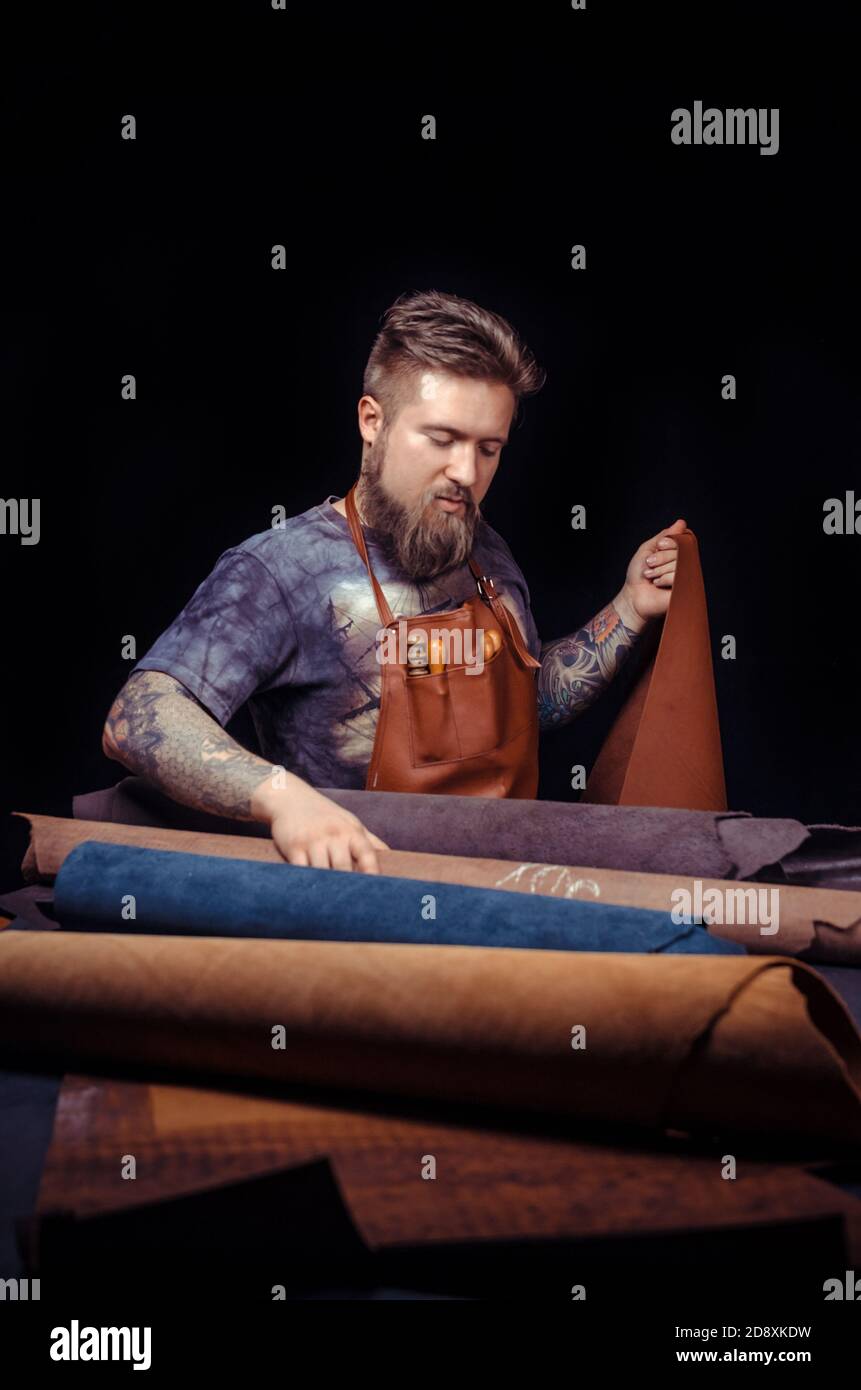 Leather Tanner Rack Leather Tanner creates quality product of leather Stock Photo - Alamy
