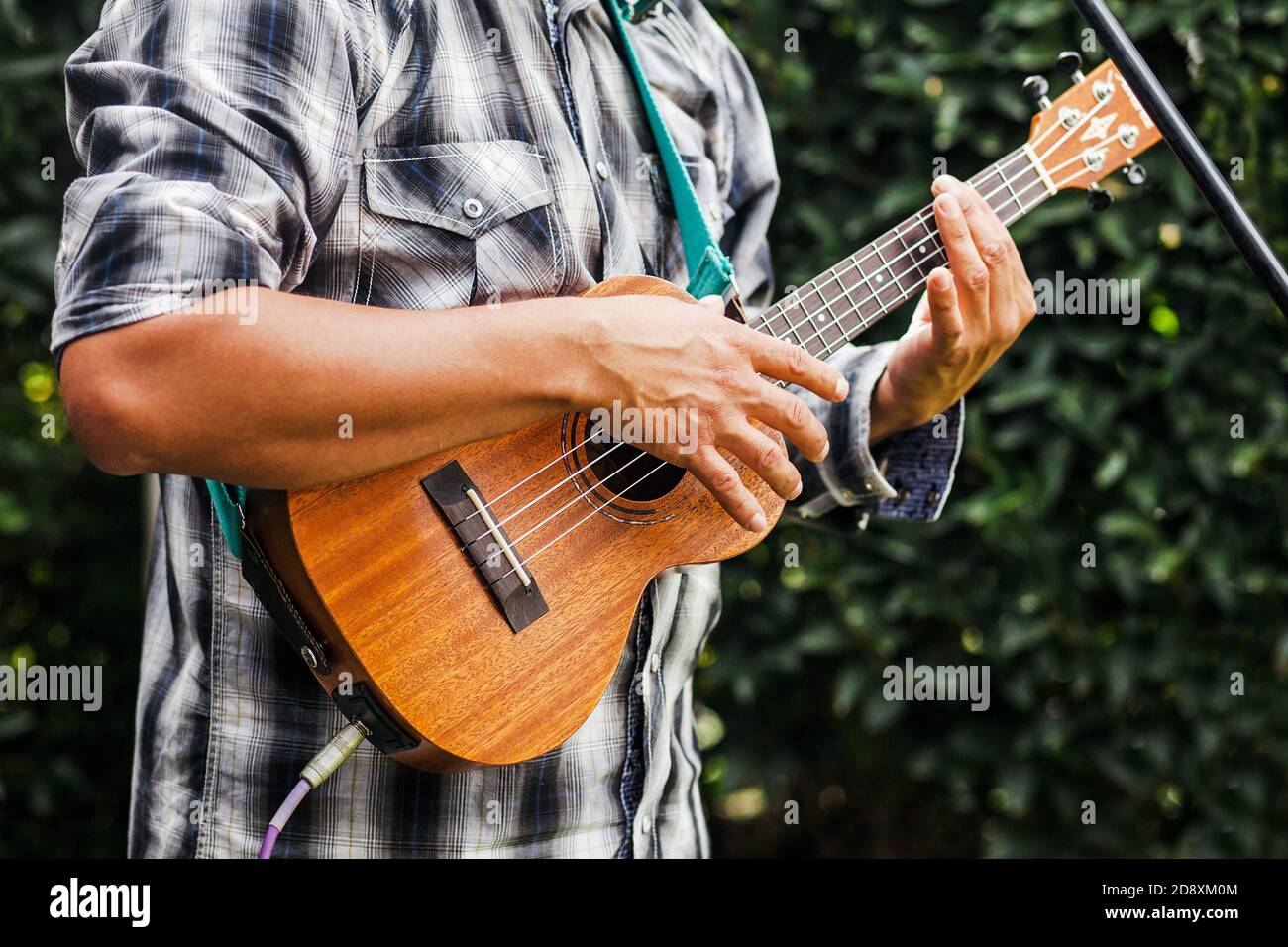 latin musician playing a guitar at the street in Mexico city Stock Photo