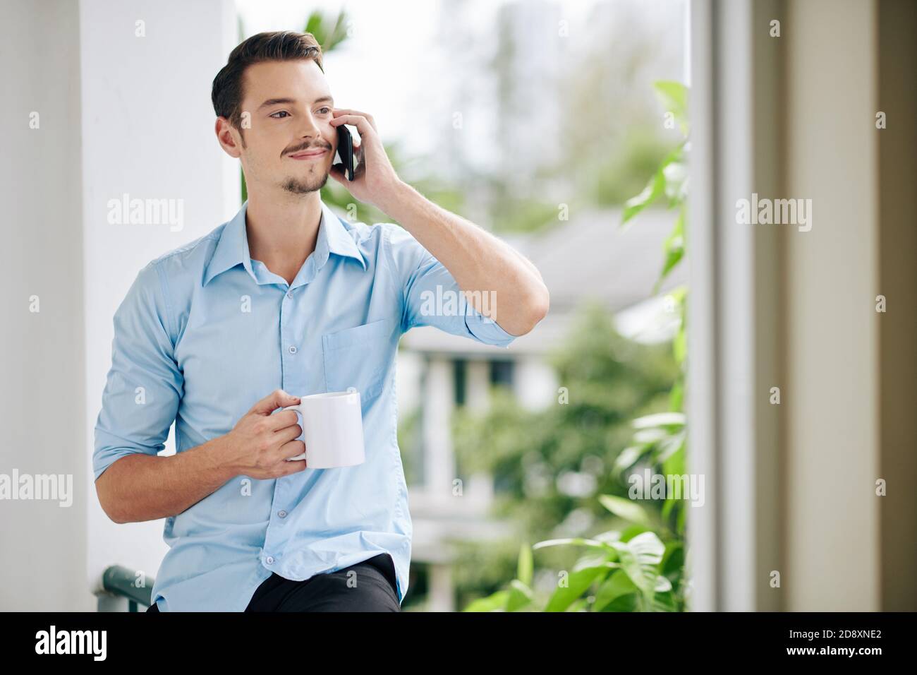 Positive man talking on phone Stock Photo