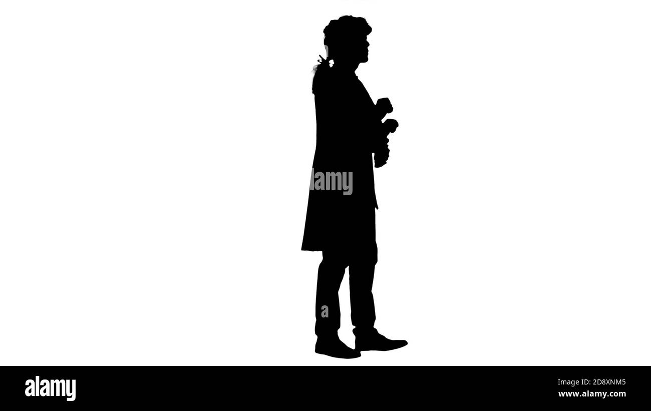 Wide shot. Side view. Silhouette Man in old-fashioned laced frock coat and white wig thinking. Professional shot in 4K resolution. 047. You can use it Stock Photo