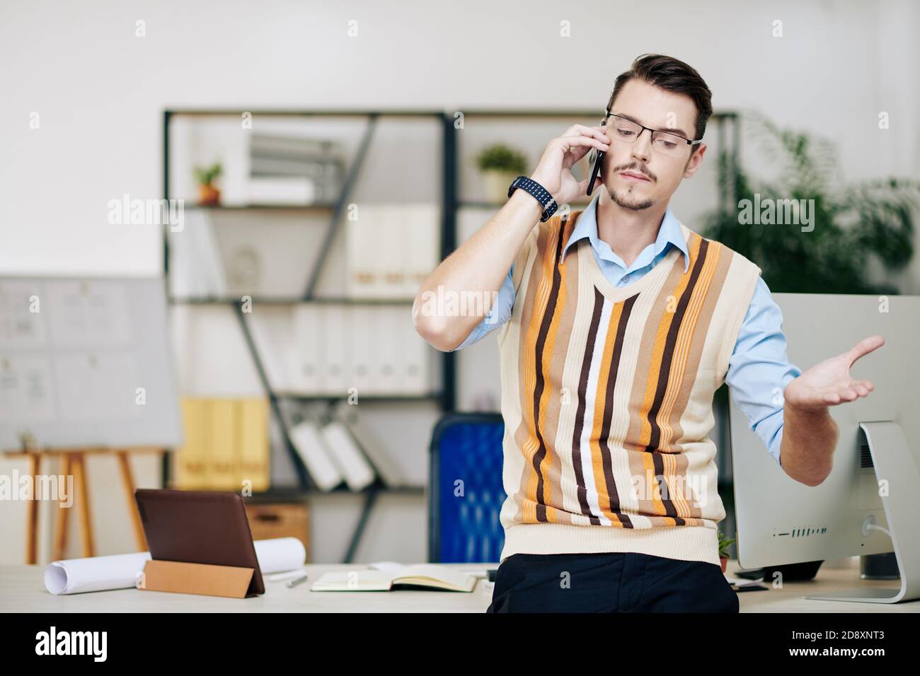 Serious entrepreneur talking on phone Stock Photo