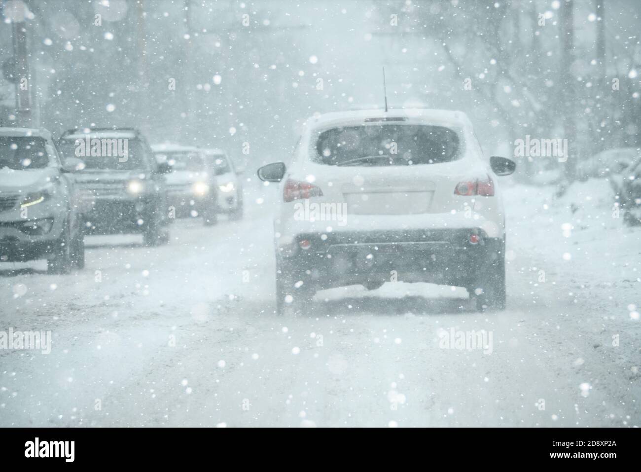 The car is driving on a winter city in a blizzard Stock Photo - Alamy