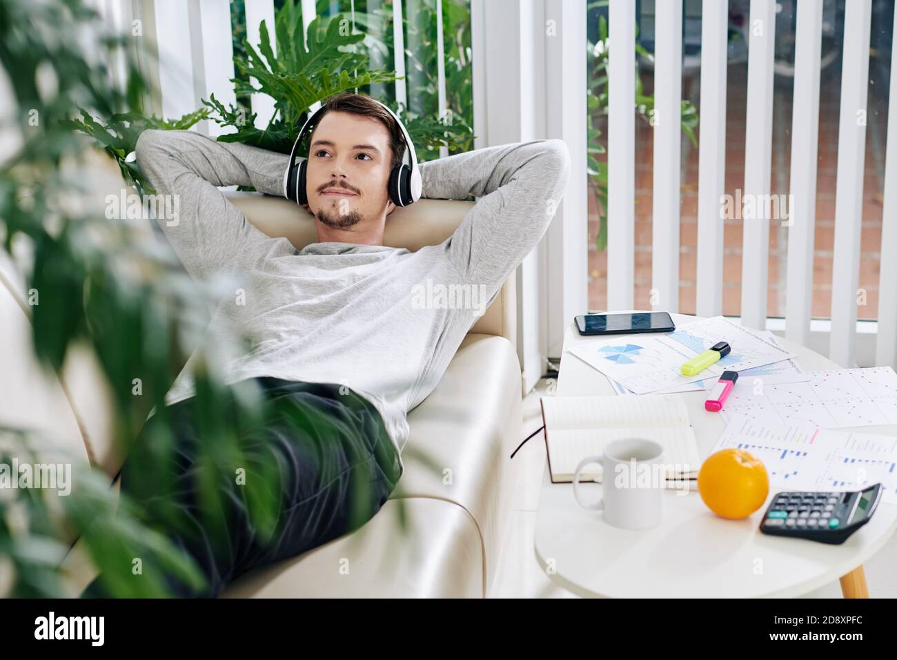 Young man resting on sofa Stock Photo