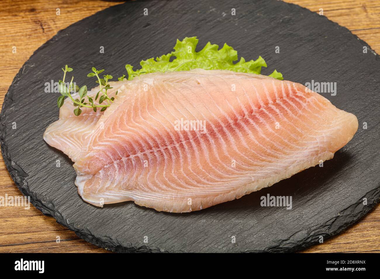 Raw tilapia fish fillet for cooking Stock Photo Alamy