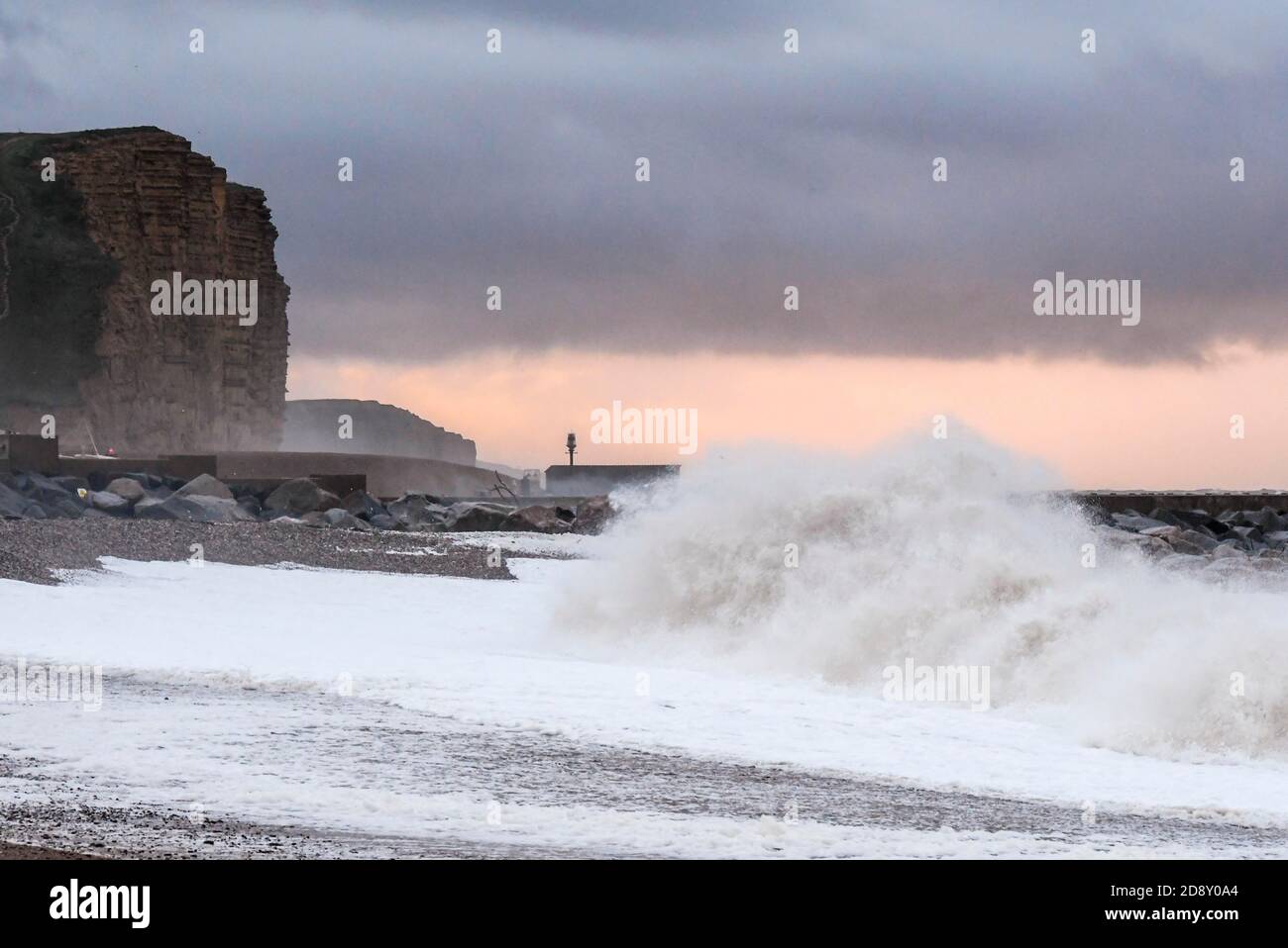 West Bay, Dorset, UK.  2nd November 2020.  UK Weather.  Stormy seas crash ashore on the beach at sunrise at the seaside resort of West Bay in Dorset.  Picture Credit: Graham Hunt/Alamy Live News Stock Photo