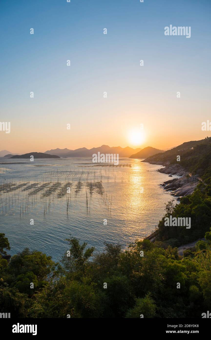 Beautiful scenery of sunset by the sea Stock Photo - Alamy
