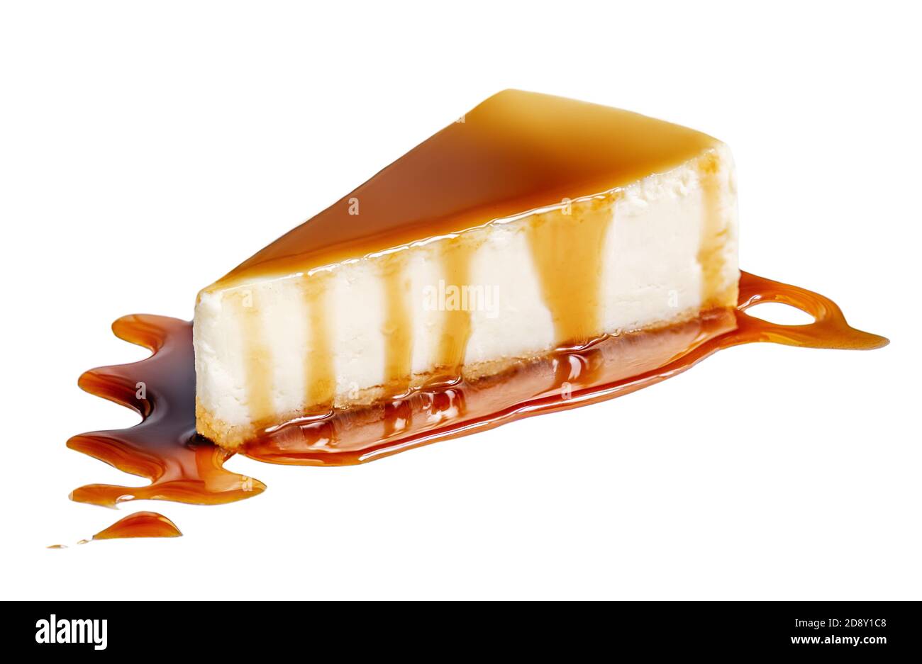 Piece of fresh Cheesecake with toffee candies and caramel sauce isolated on white background