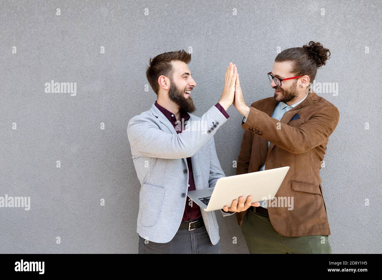 Portrait of happy businessmen using digital devices at meeting Stock Photo