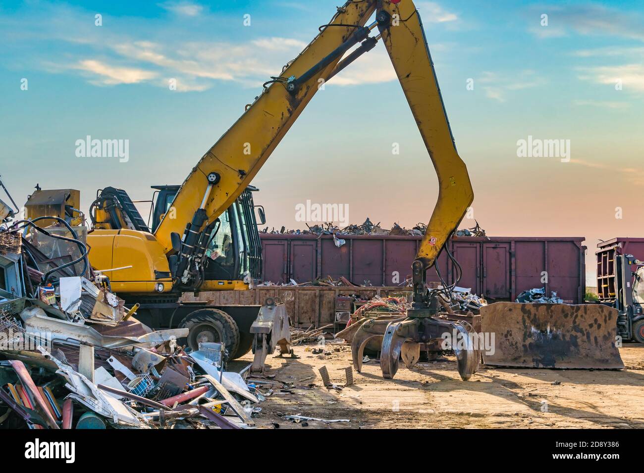 Yellow crane in landfill. Waste and pollution management Stock Photo