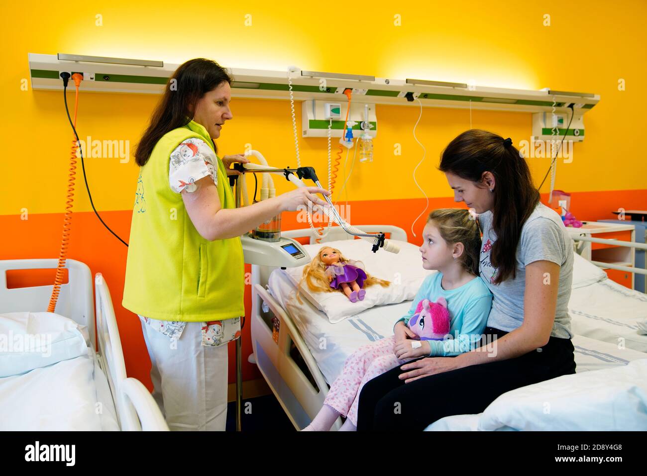 Treatment of a pediatric patient in a pediatric department in a hospital by inhalation in the presence of a mother Stock Photo