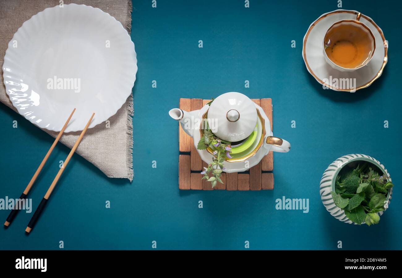 Empty white plate, chopsticks and herbal tea Stock Photo
