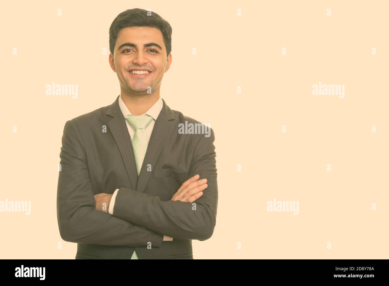Portrait of happy young handsome Persian businessman in suit smiling ...