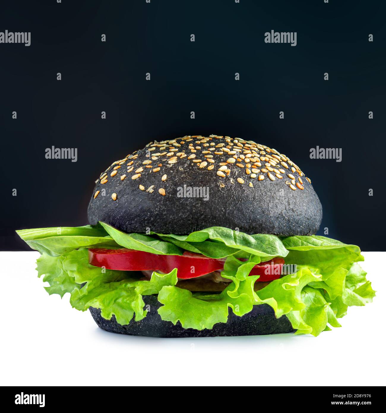 Tasty vegetarian burger with lettuce and vegetables isolated on white