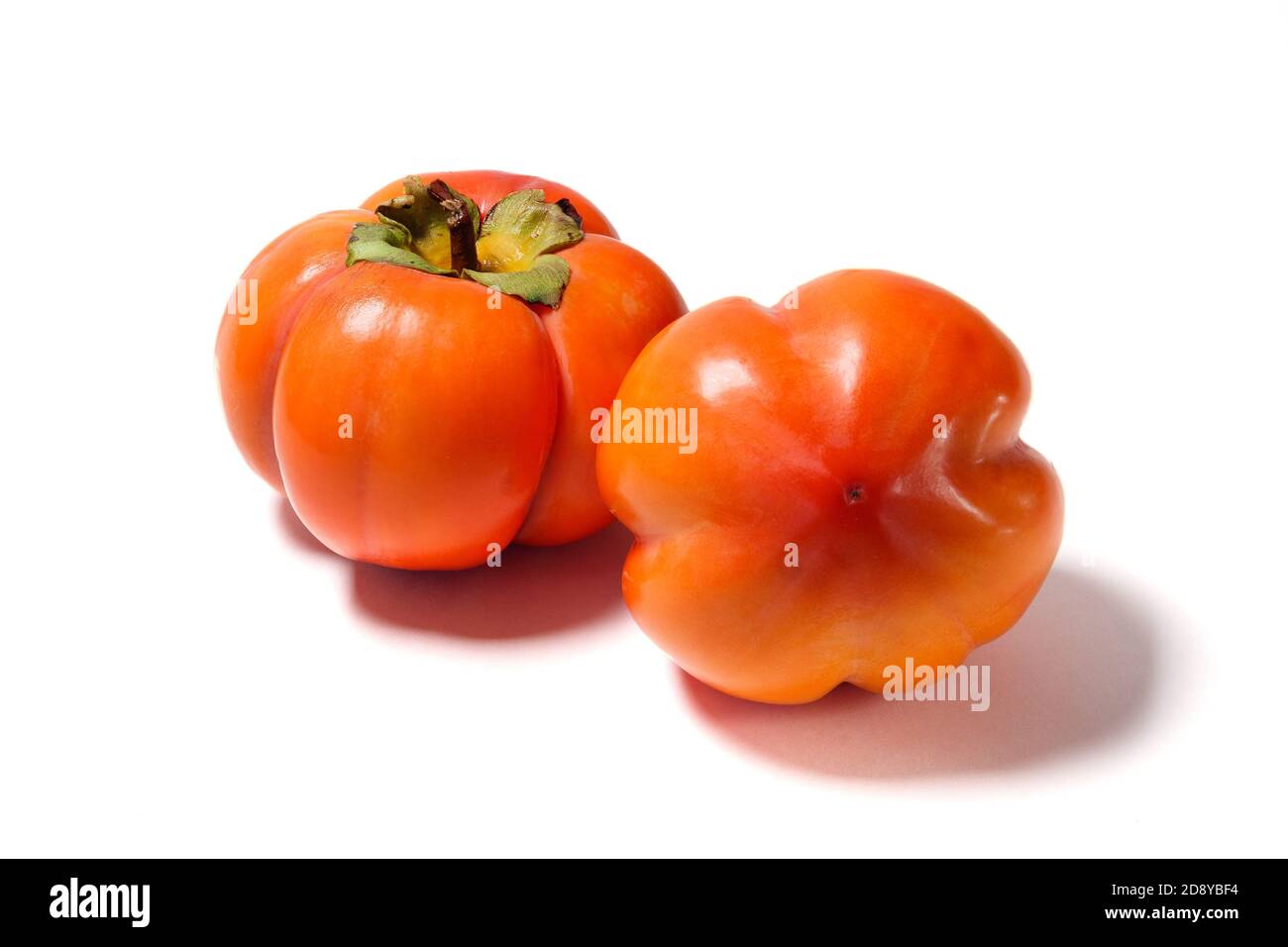 Two Persimmons isolated on white background. Side vew Stock Photo