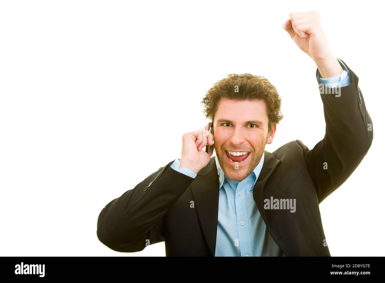 Young man in business attire is cheering on his cell phone Stock Photo