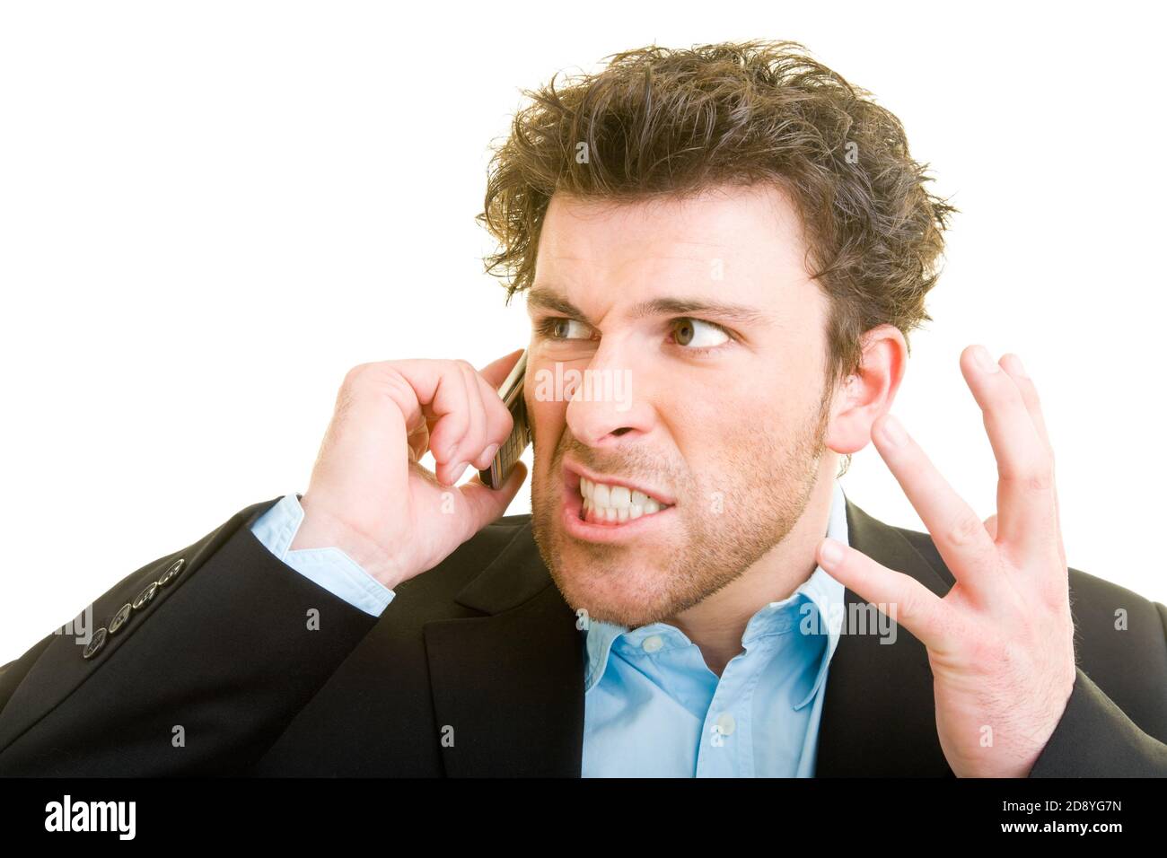 Young man in business attire is angry on his cellphone Stock Photo