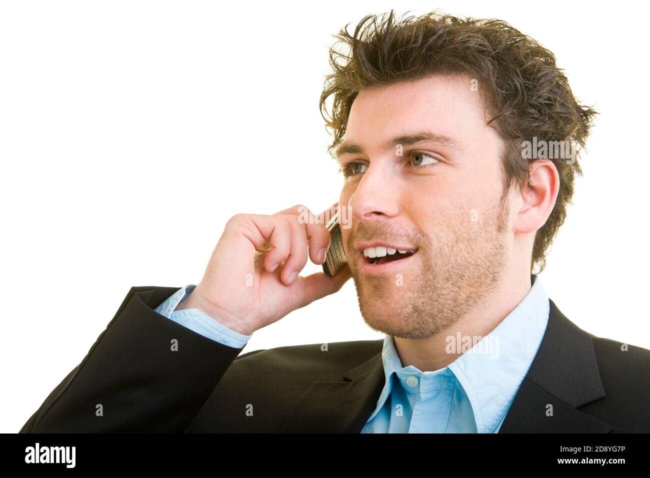 Young man in business attire is talking on his cellphone Stock Photo
