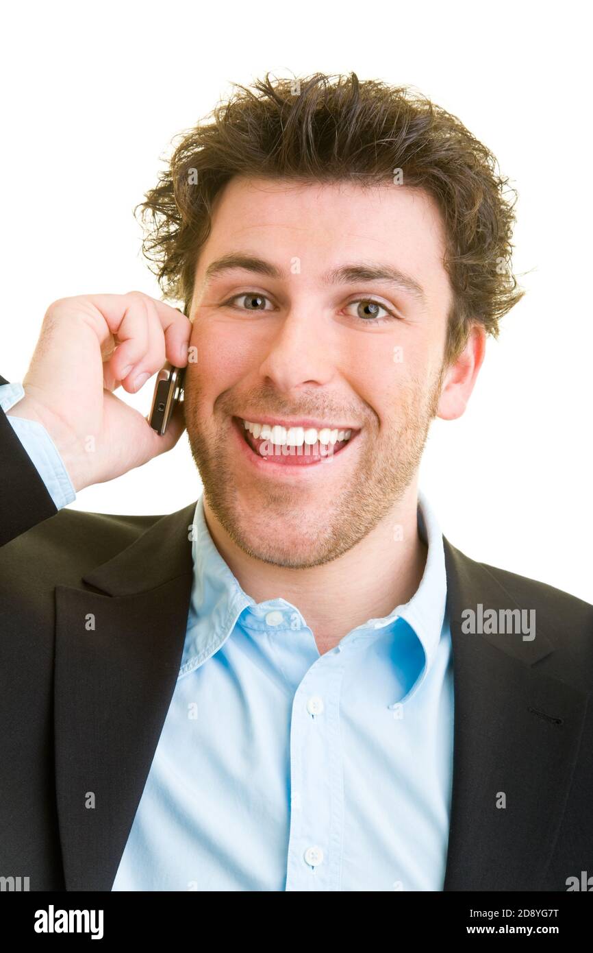 Young man in business attire is talking on his cell phone while laughing Stock Photo