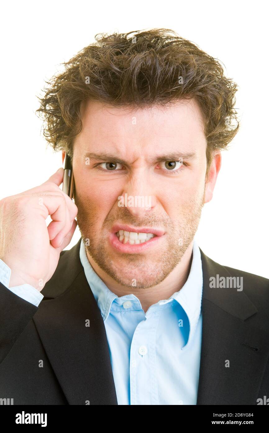 Young man in business attire is angry on his cellphone Stock Photo