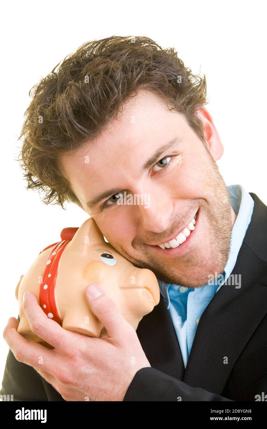 Young man in suit leans on his piggy bank Stock Photo - Alamy