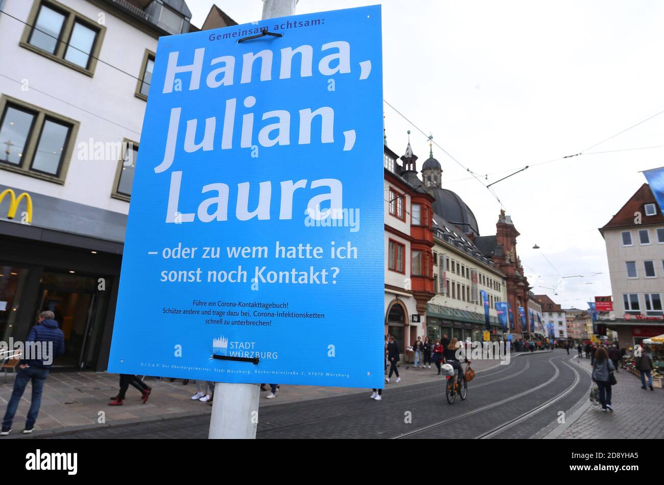30 October 2020, Bavaria, Würzburg: A poster in the city centre reads 'Attentive together: Hanna, Julian, Laura - or who else did I have contact with? The city of Würzburg recommends keeping a contact diary and has put up posters at around 200 locations for this purpose. Photo: Karl-Josef Hildenbrand/dpa Stock Photo