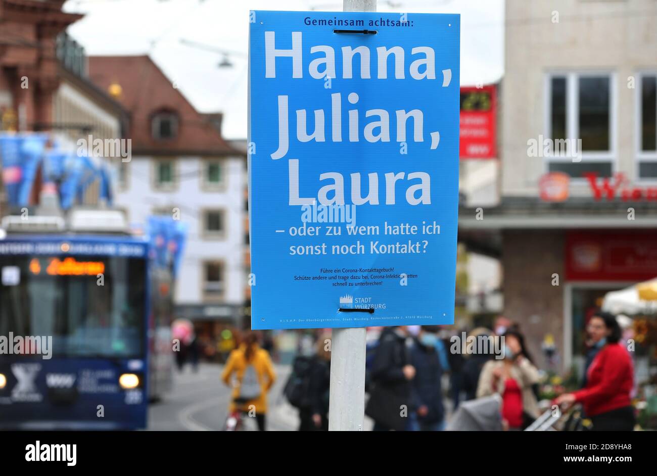 30 October 2020, Bavaria, Würzburg: On a blue poster in the city centre you can read 'Attentive together: Hanna, Julian, Laura - or who else did I have contact with? The city of Würzburg recommends keeping a contact diary and has put up posters at around 200 locations for this purpose. Photo: Karl-Josef Hildenbrand/dpa Stock Photo