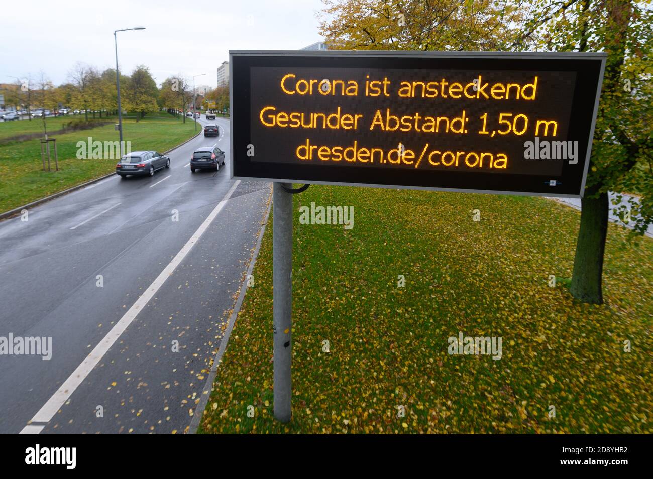 Dresden, Germany. 02nd Nov, 2020. A digital display board in downtown Dresden reads 'Corona is contagious Healthy distance: 1.50m'. The federal and state governments have decided on a partial lockdown starting on the same day. Among other things, restaurants, leisure facilities and cultural institutions will have to close. Credit: Sebastian Kahnert/dpa-Zentralbild/dpa/Alamy Live News Stock Photo