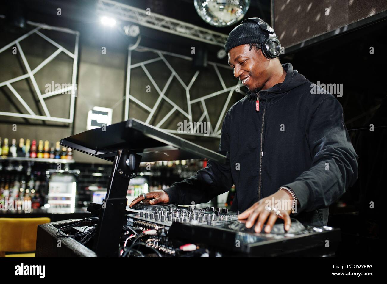 African american dj play music on decks at night club Stock Photo Alamy