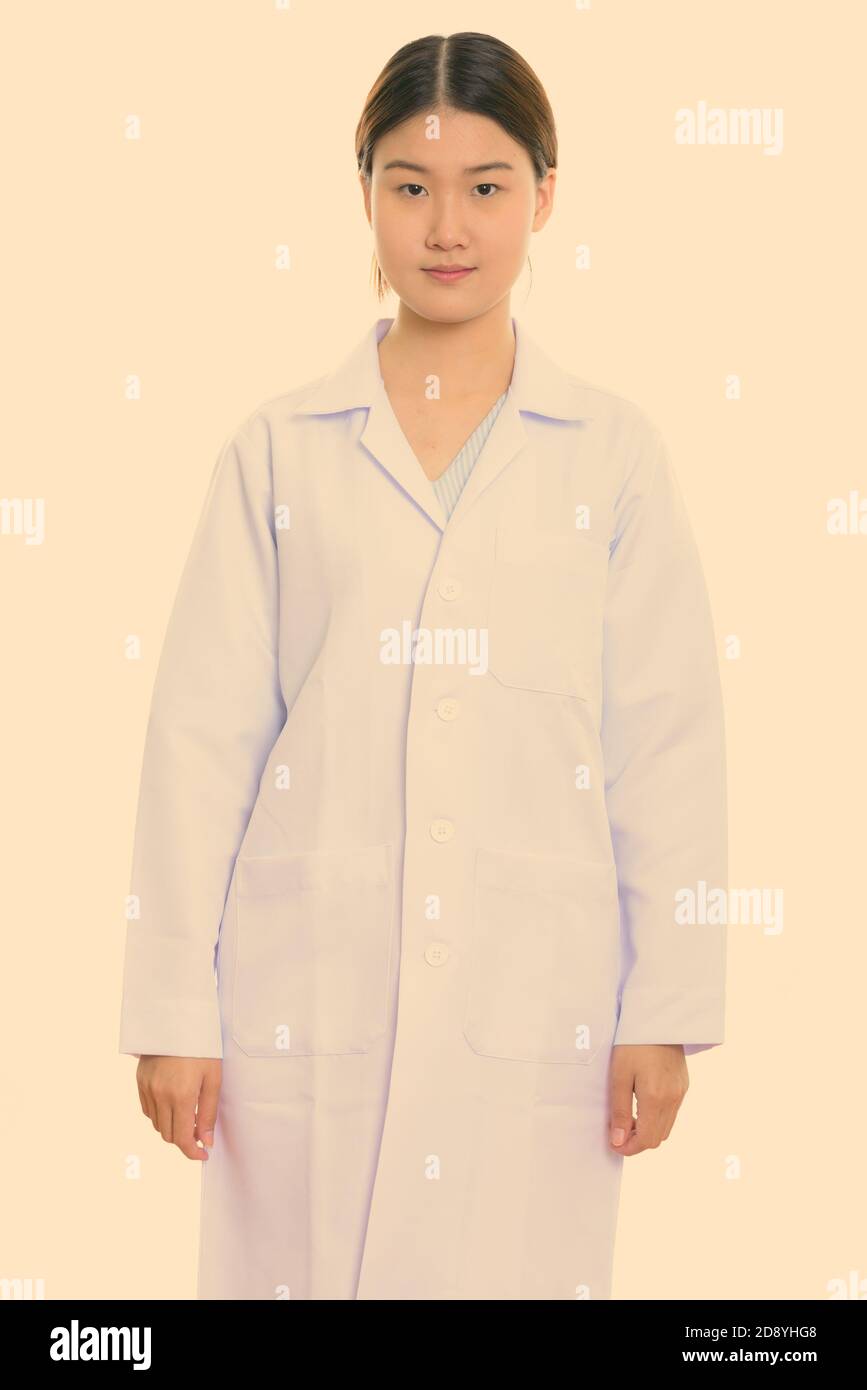 Studio shot of young beautiful Asian woman doctor standing Stock Photo ...