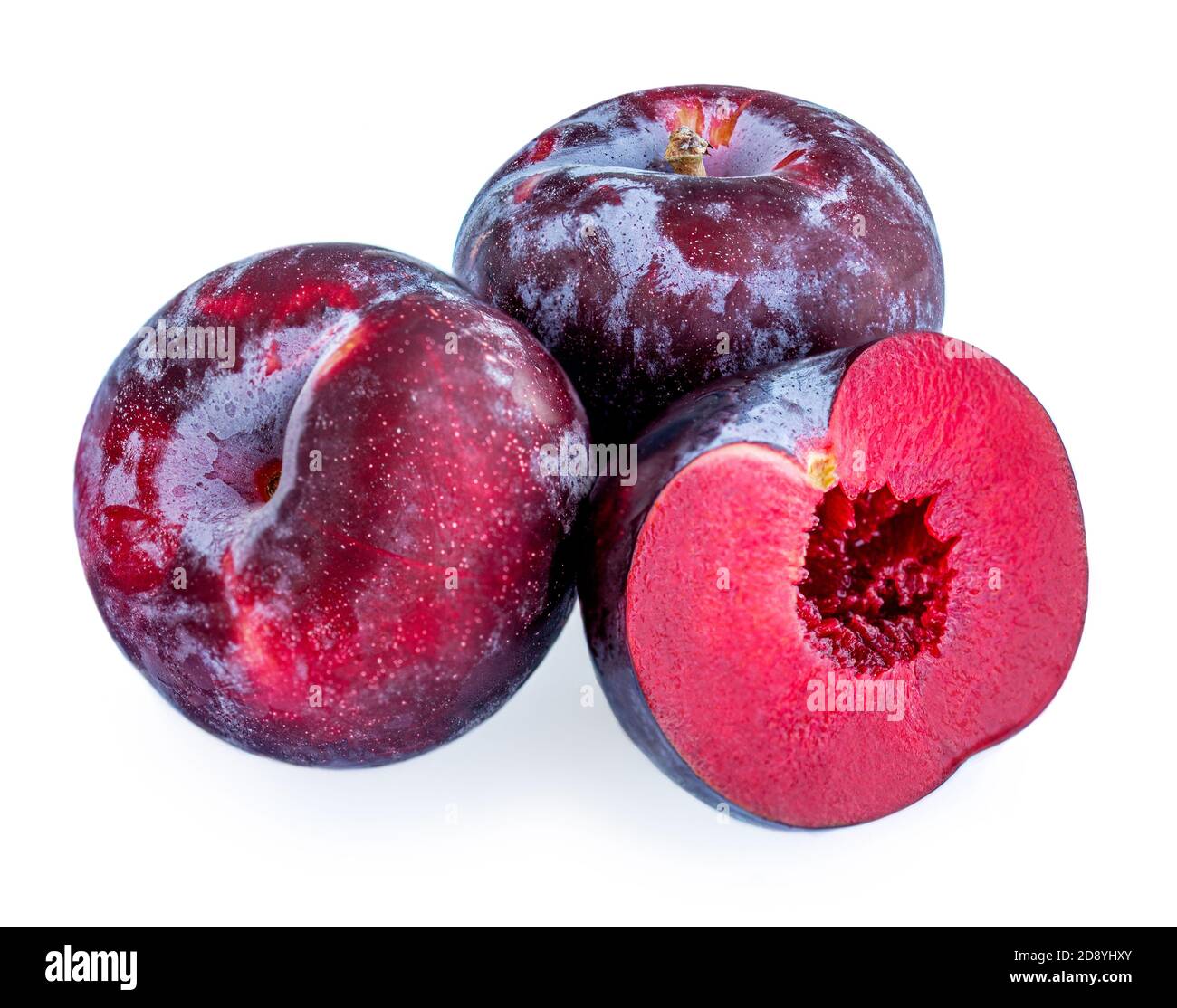 Plum fruits isolated on white background. Whole and a half of blue plums Macro Stock Photo