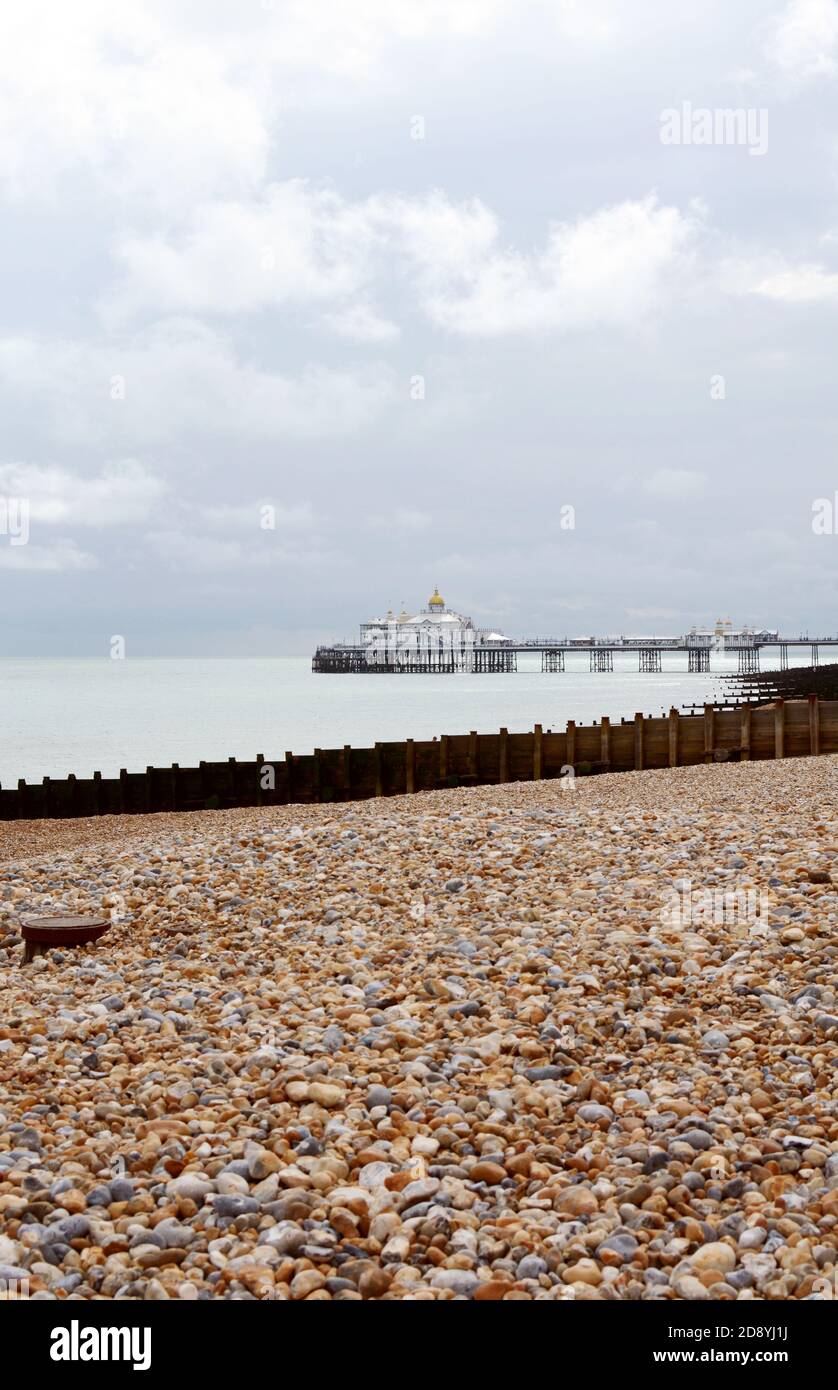 Eastbourne pleasure pier, opened in 1870, above a calm sea on the East Sussex coast, with copy space on sky and beach Stock Photo