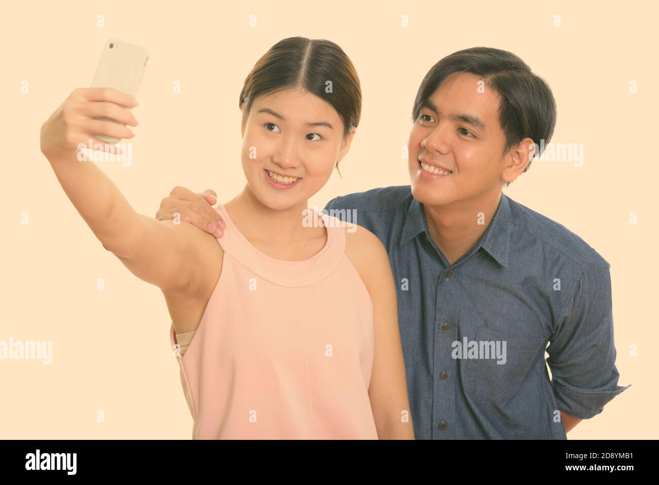 Young happy Asian couple smiling while taking selfie picture with ...