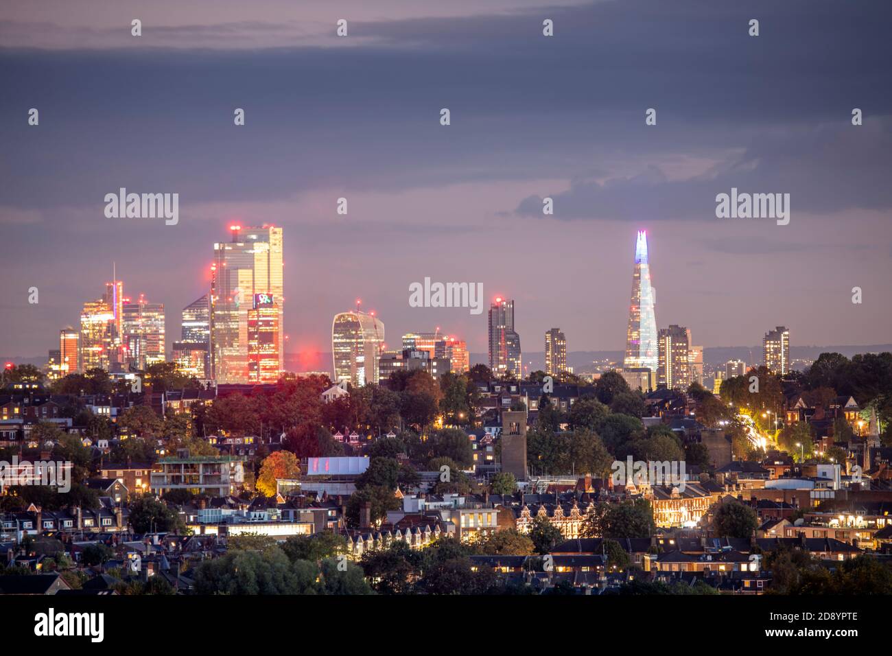 UK, London, urban skyline of city centre from Muswell Hill. Distant suburban view, illuminated buildings, Shard, 22 Bishopsgate, CBD, downtown, dusk Stock Photo