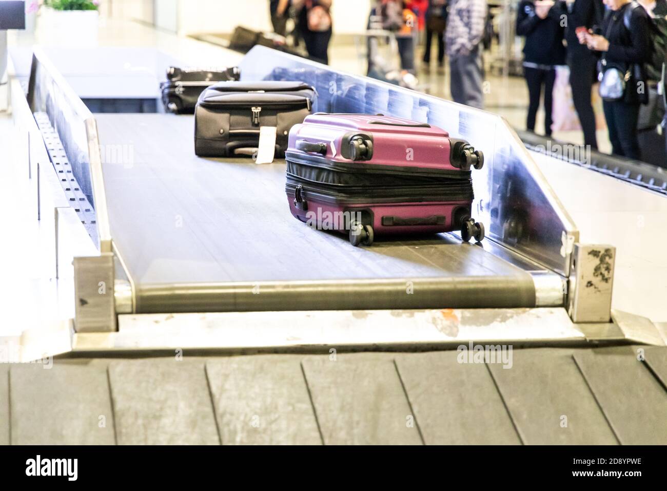 Baggage luggage on conveyor carousel belt at airport arrival Stock