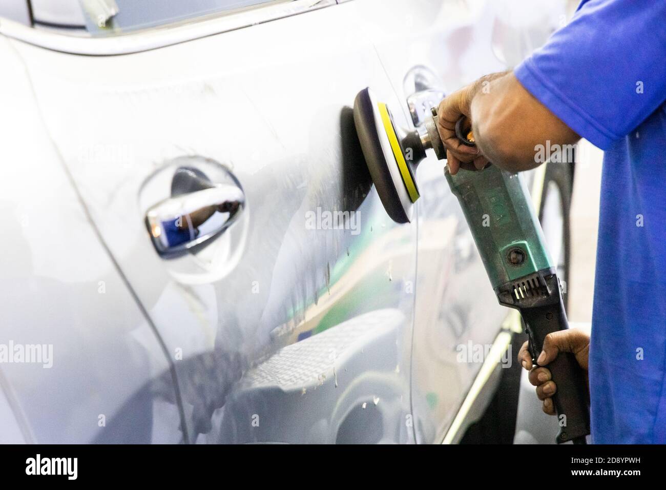 Worker buffer car with polish wax using grinder machine Stock Photo Alamy