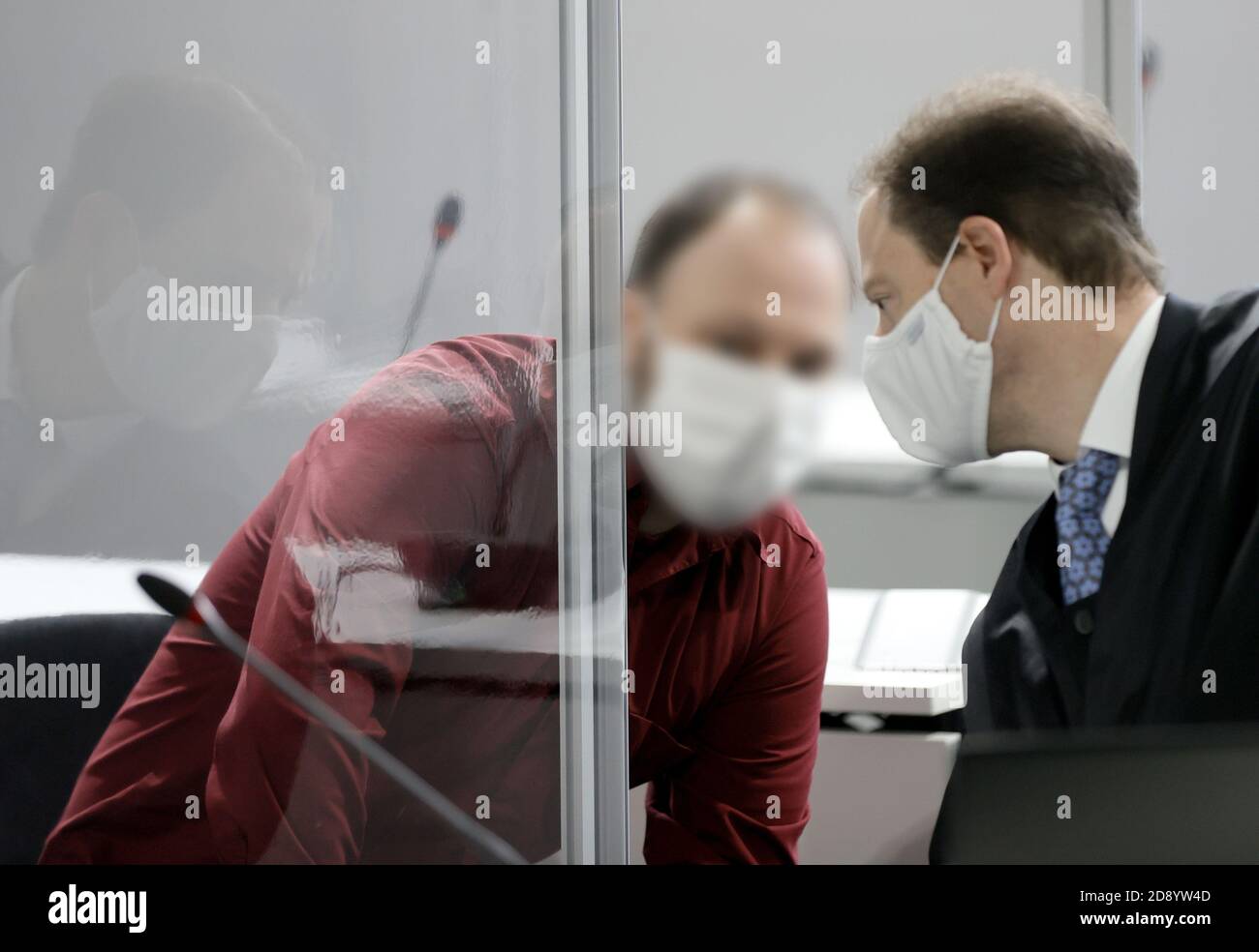 02 November 2020, Hessen, Wiesbaden: The defendant talks to his lawyer Oliver Baars (R) during the trial in the abuse complex Bergisch Gladbach in the courtroom of the regional court. The 39-year-old defendant is accused of having sexually abused his biological children, including an infant and a stepchild, and of having sent pictures of the crimes via chat groups. Investigations into the case had begun after searches of a 43-year-old family man in Bergisch Gladbach, North Rhine-Westphalia, in autumn 2019. Photo: Ronald Wittek/EPA-Pool/dpa - ATTENTION: The employees of the Regional Court of Wi Stock Photo