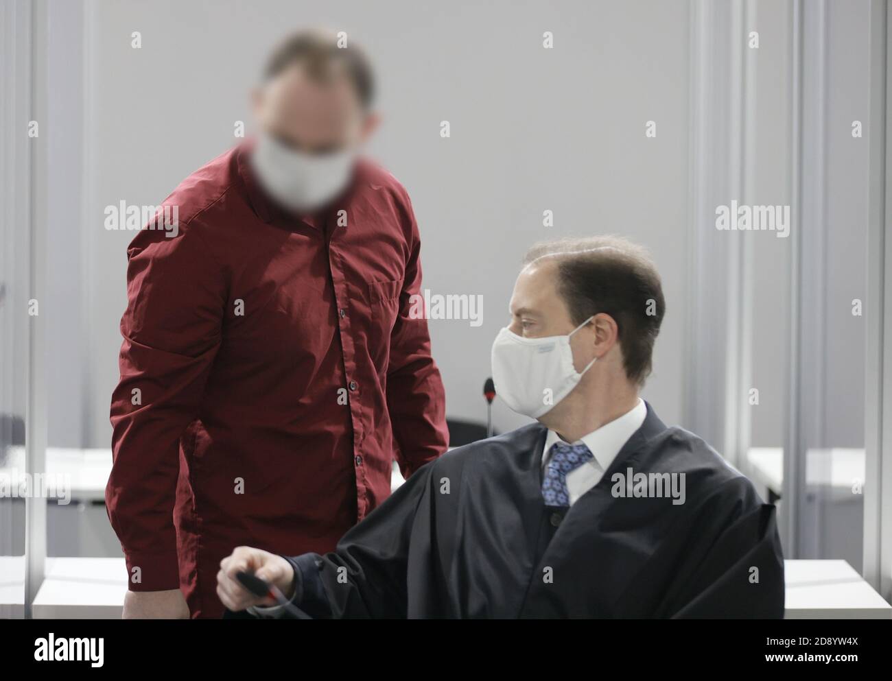 02 November 2020, Hessen, Wiesbaden: The accused stands next to his lawyer Oliver Baars (R) in the courtroom of the regional court during the trial in the abuse complex Bergisch Gladbach. The 39-year-old defendant is accused of having sexually abused his biological children, including an infant and a stepchild, and of having sent pictures of the crimes via chat groups. Investigations into the case had begun after searches of a 43-year-old family man in Bergisch Gladbach, North Rhine-Westphalia, in autumn 2019. Photo: Ronald Wittek/EPA-Pool/dpa - ATTENTION: The employees of the Regional Court o Stock Photo