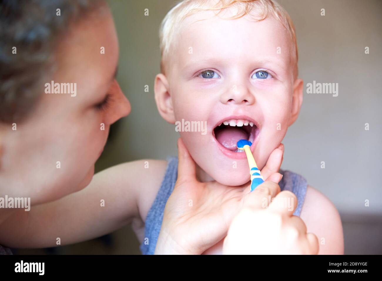 Mom teaches and helps her threeyearold son to brush his teeth, closeup Stock Photo Alamy