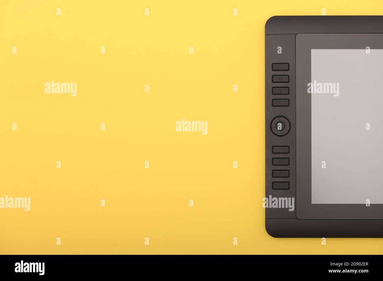 Graphic monitor on yellow color table. Black tablet computer with blank ...