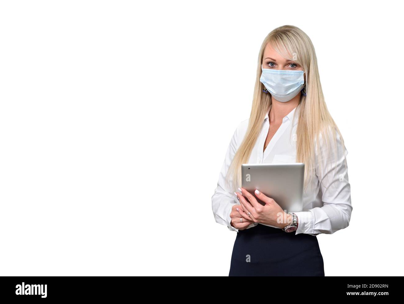 A young woman office manager in a face mask with a digital tablet on a wihite background Stock Photo