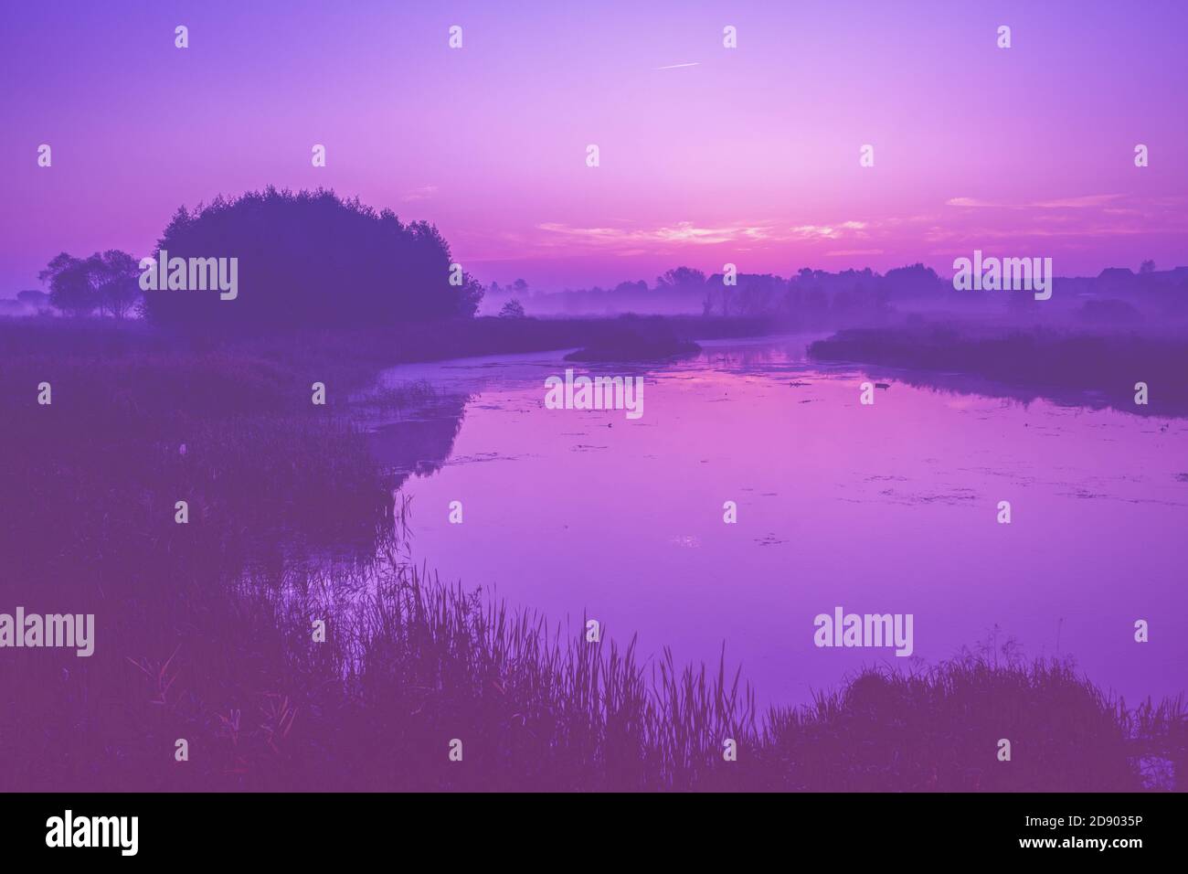 Magical sunrise over the lake. Serene lake in the early misty morning ...