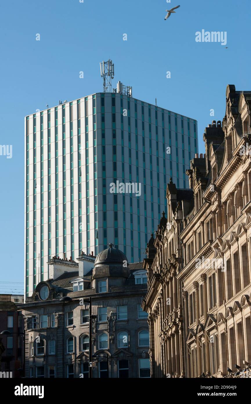 High rise office block towering above older buildings in the city of