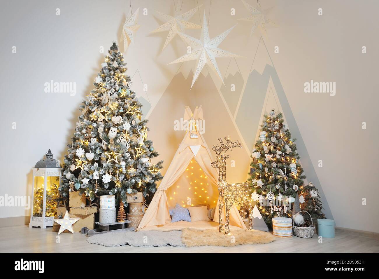 Playroom for children with Christmas decorations, gifts, tent and Christmas trees Stock Photo